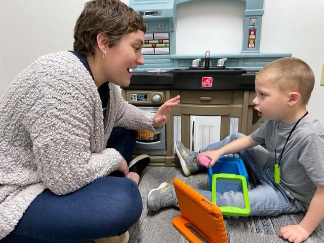 SLP student with a young patient